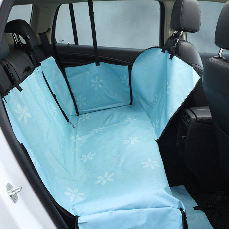 Blue dog car back seat cover installed across a rear seat