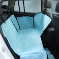 Blue dog car back seat cover installed across a rear seat