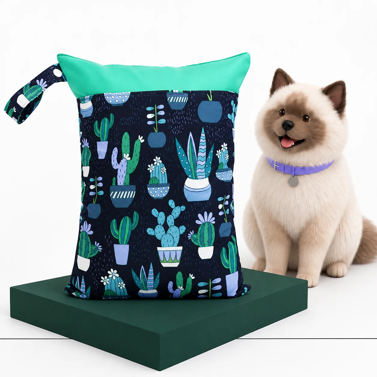 Navy botanical Wet Walk Bag displayed beside Umi on a white Avorily studio set